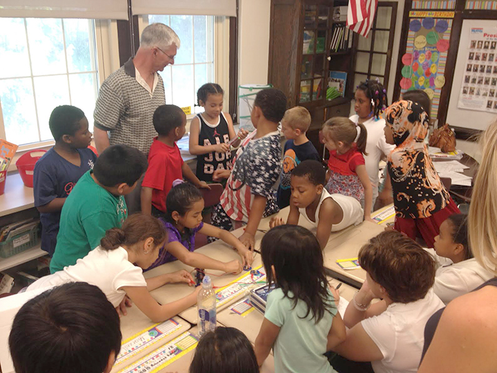     Art Tooker works with kids at Hughes Elementary School in Utica in STEM / NANO instruction.