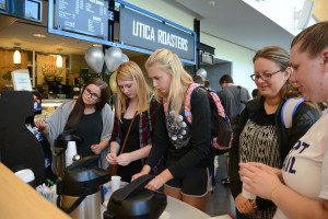 Students try free samples of Utica Coffee during the ribbon cutting ceremony on the new retail space of the SUNY Poly Student Center in Utica.