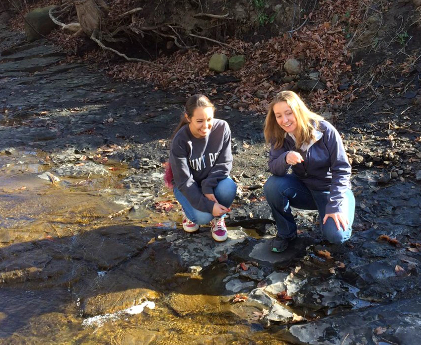 Assistant Professor Carolyn Rodak and Bianca Little during the Civil Engineering Hydrology and Stormwater management class. Classes on campus uses the stream that runs through campus as an outdoor lab.