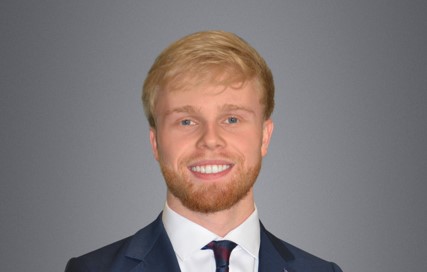 Zack Nesbitt photo. He is wearing suit. Has blonde hair.