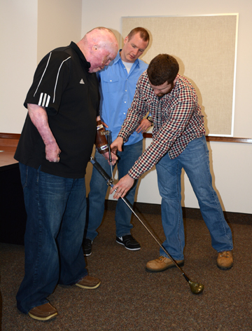 Mechanical Engineering Technology students work with a disabled veteran to create an adaptive golf club.