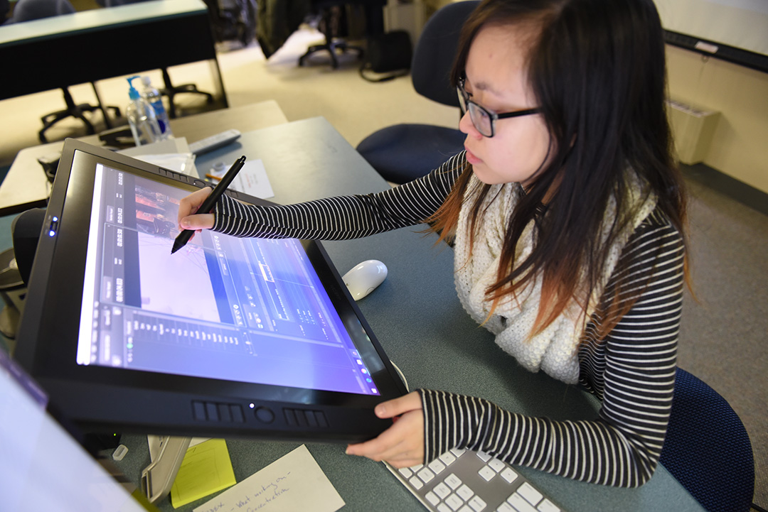 student drawing on an electronic tablet