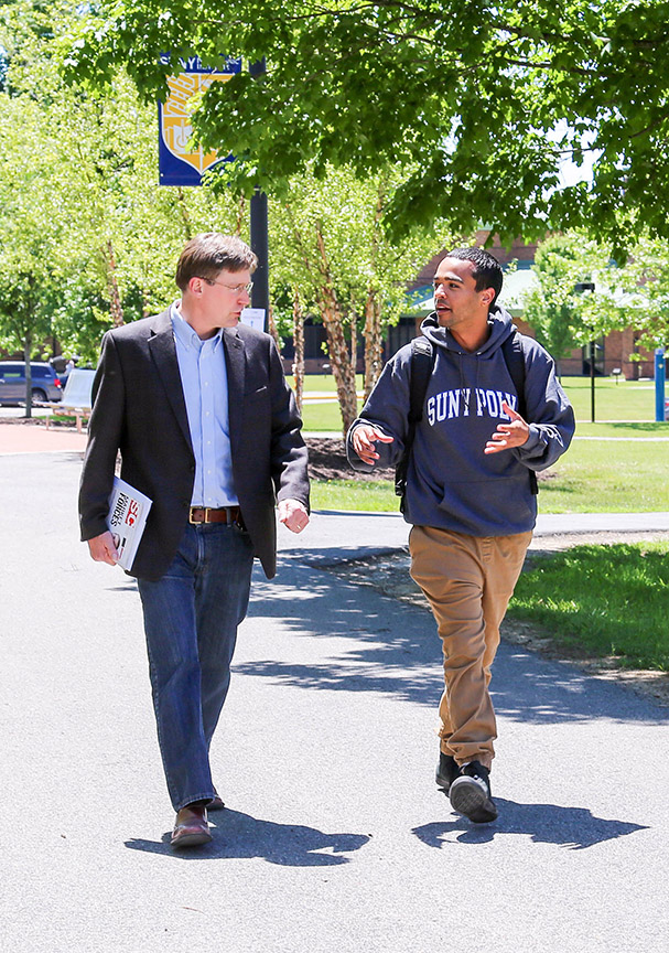 Professor John Marsh walking with student